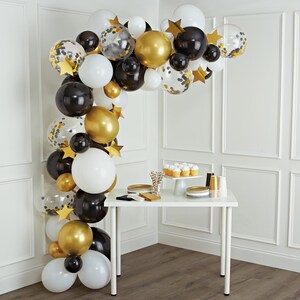 black, white and gold balloon arch